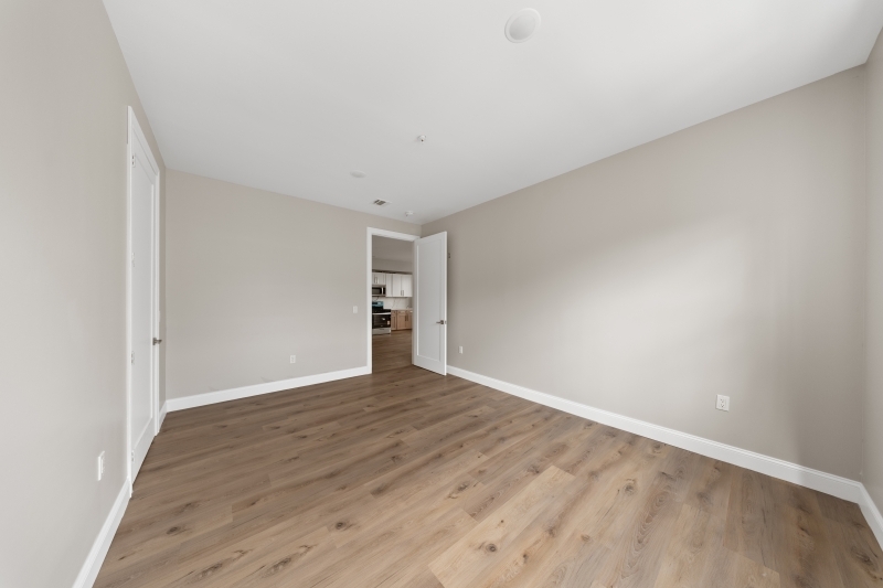 17 Wickham Street, Unit 203 Passaic, NJ 07055 - Photo 9 of 15 a view of an empty room with wooden floor