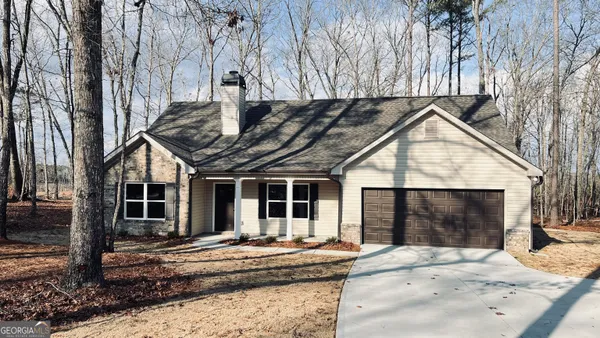 a front view of house with garage and yard