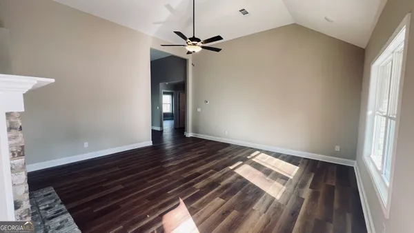 a view of a room with wooden floor and staircase