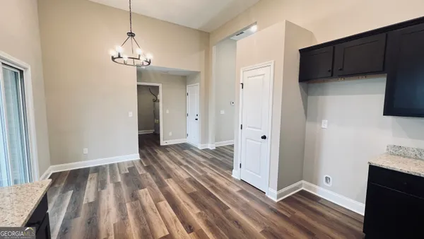 a view of a livingroom with wooden floor and stairs