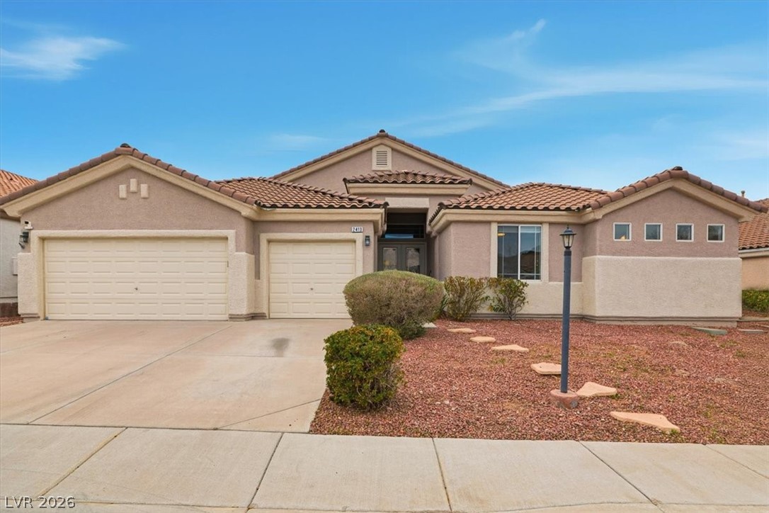 2413 Gold Camp Street Henderson, NV 89002 - Photo 1 of 66 Mediterranean / spanish-style house with stucco siding, concrete driveway, a garage, and a tile roof