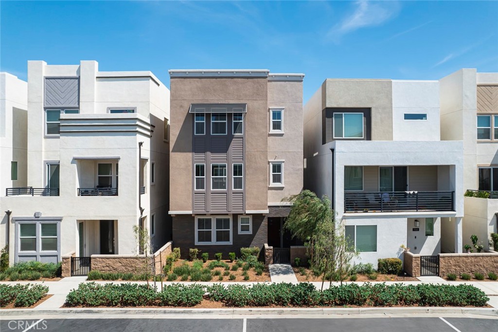 a front view of a residential apartment building with a yard