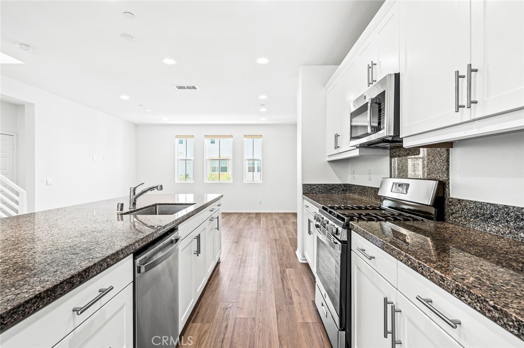 9560 Hammock Place Rancho Cucamonga, CA 91730 - Photo 13 of 48 a kitchen with stainless steel appliances granite countertop a stove and a sink