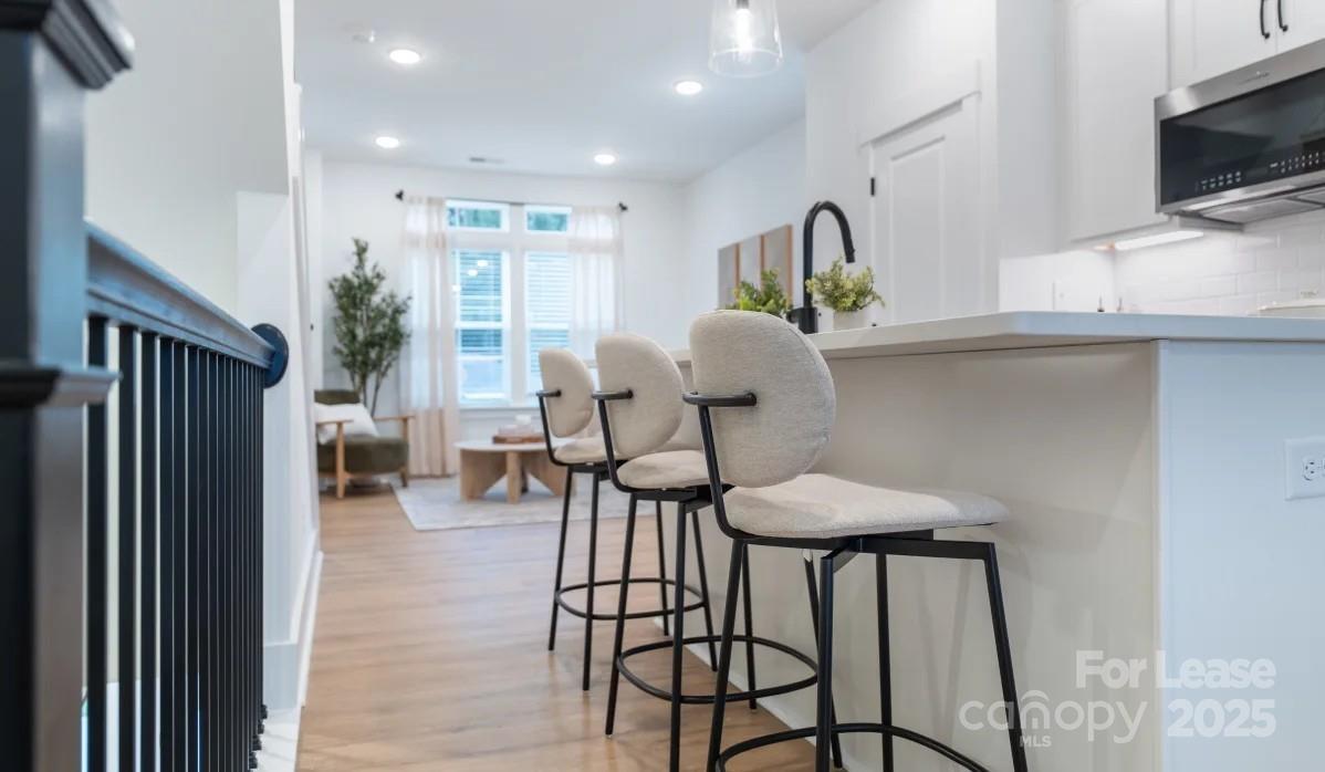 2616 Rannoch Street Charlotte, NC 28208 - Photo 5 of 25 a view of a hallway with furniture and wooden floor