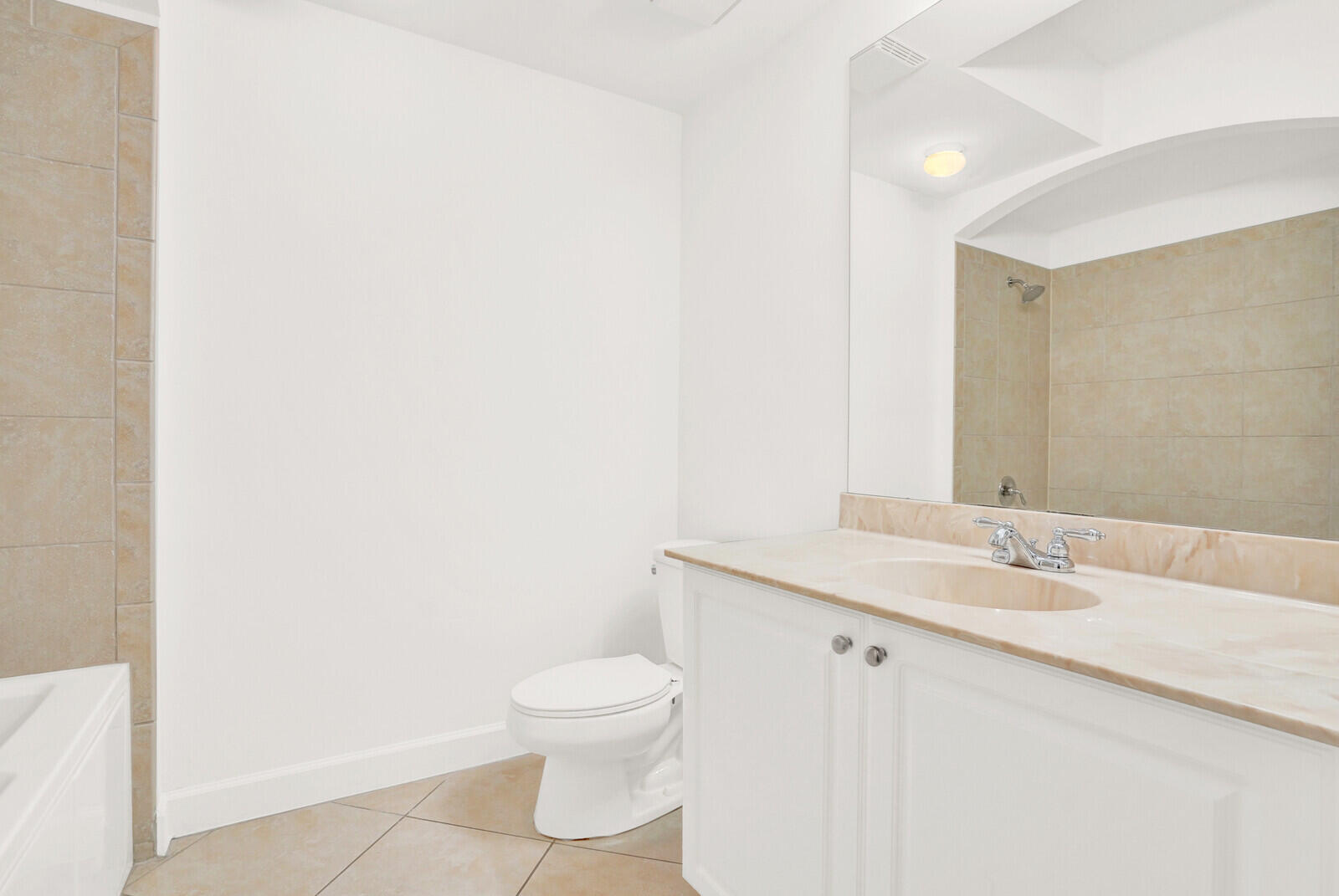 1690 Renaissance Commons Boulevard, Unit 1121 Boynton Beach, FL 33426 - Photo 14 of 32 a bathroom with a sink a toilet and a mirror