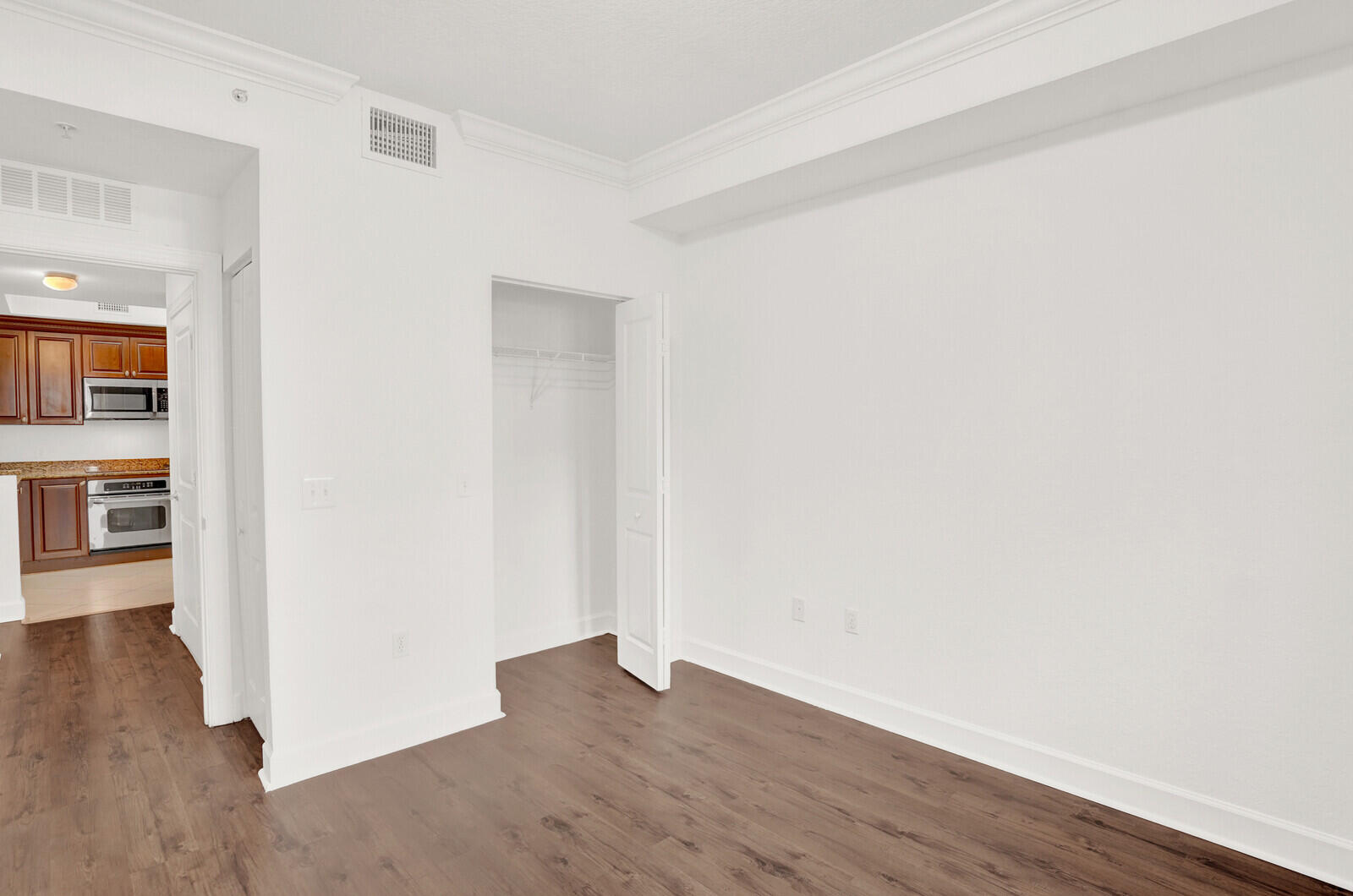 1690 Renaissance Commons Boulevard, Unit 1121 Boynton Beach, FL 33426 - Photo 14 of 35 an empty room with wooden floor