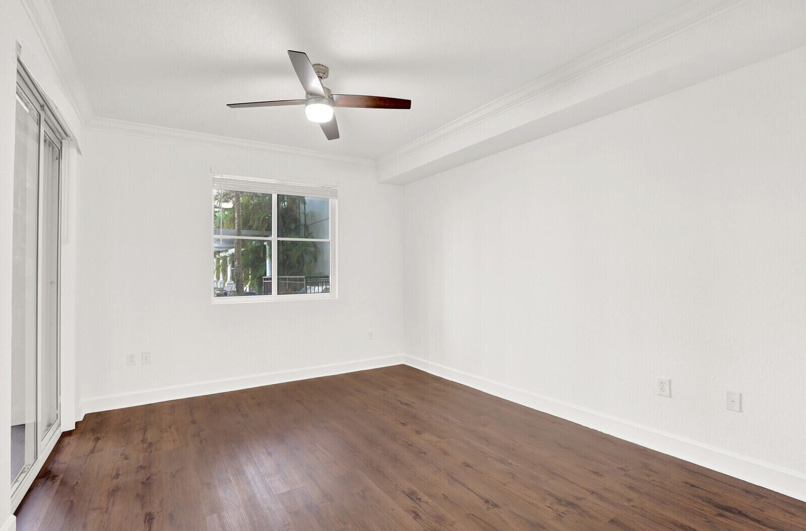 1690 Renaissance Commons Boulevard, Unit 1121 Boynton Beach, FL 33426 - Photo 16 of 32 a view of empty room with wooden floor and fan