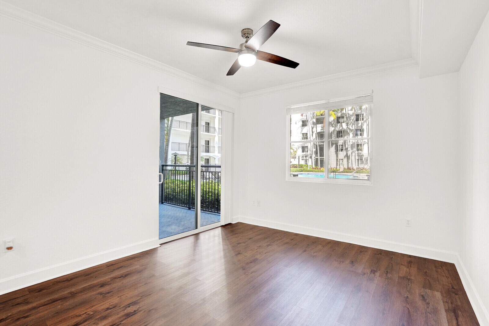 1690 Renaissance Commons Boulevard, Unit 1121 Boynton Beach, FL 33426 - Photo 17 of 35 wooden floor in an empty room with a window