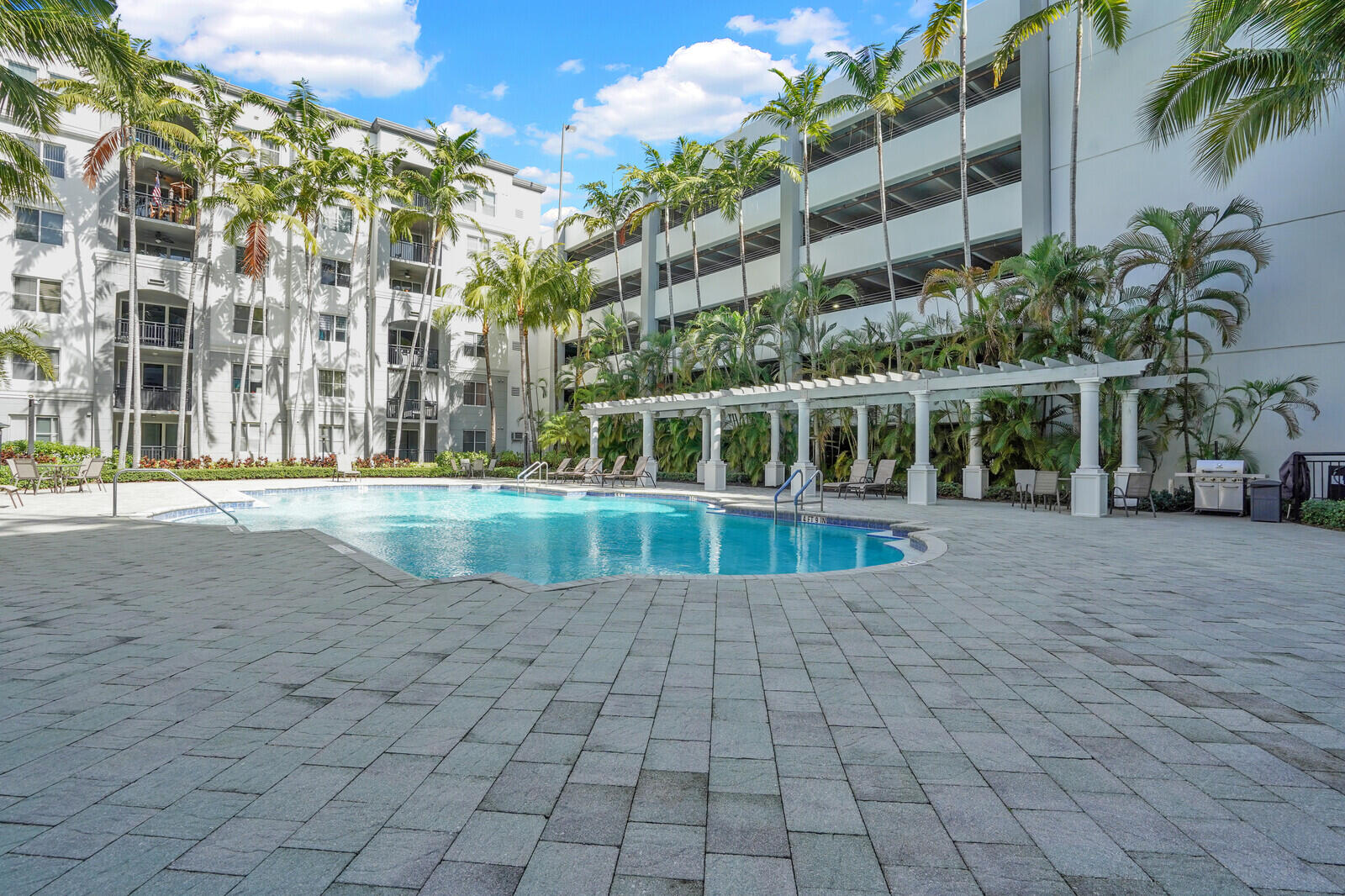 1690 Renaissance Commons Boulevard, Unit 1121 Boynton Beach, FL 33426 - Photo 25 of 32 a view of a building with a swimming pool
