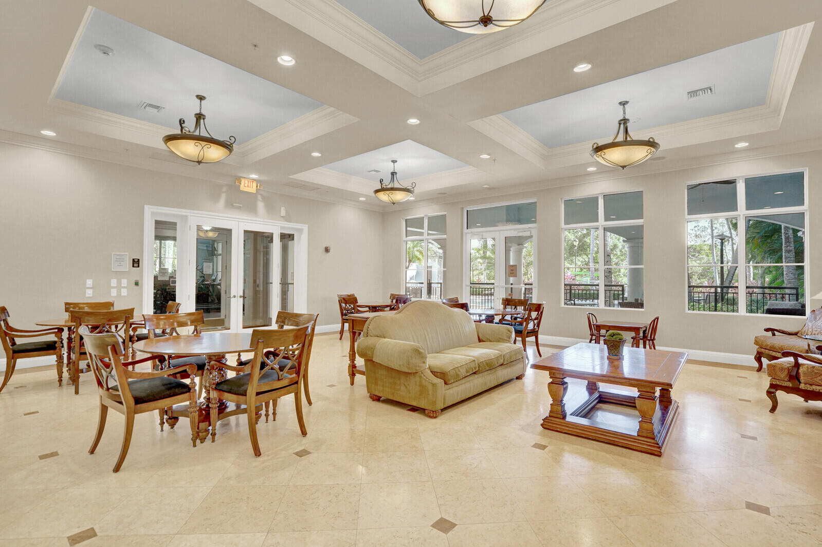 1690 Renaissance Commons Boulevard, Unit 1121 Boynton Beach, FL 33426 - Photo 29 of 32 a living room with furniture a chandelier and a dining table