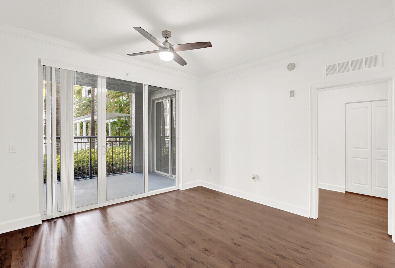 1690 Renaissance Commons Boulevard, Unit 1121 Boynton Beach, FL 33426 - Photo 4 of 32 a view of empty room with wooden floor and fan