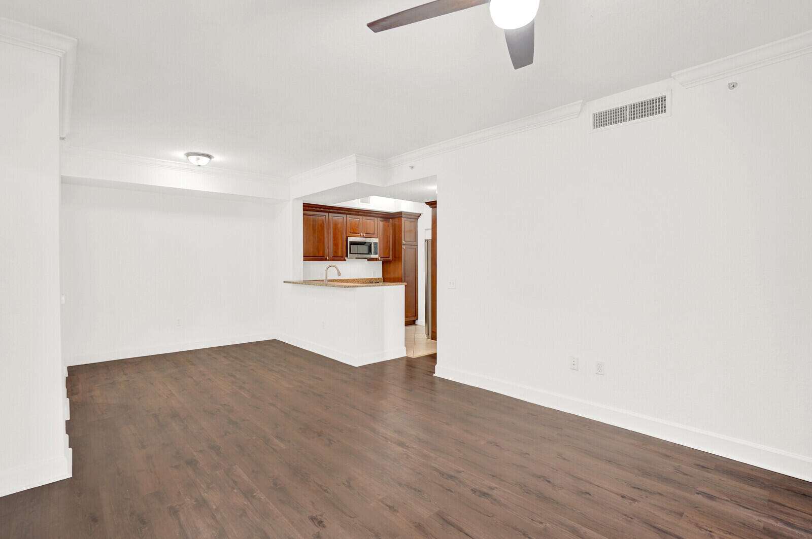 1690 Renaissance Commons Boulevard, Unit 1121 Boynton Beach, FL 33426 - Photo 5 of 32 a view of an empty room with wooden floor