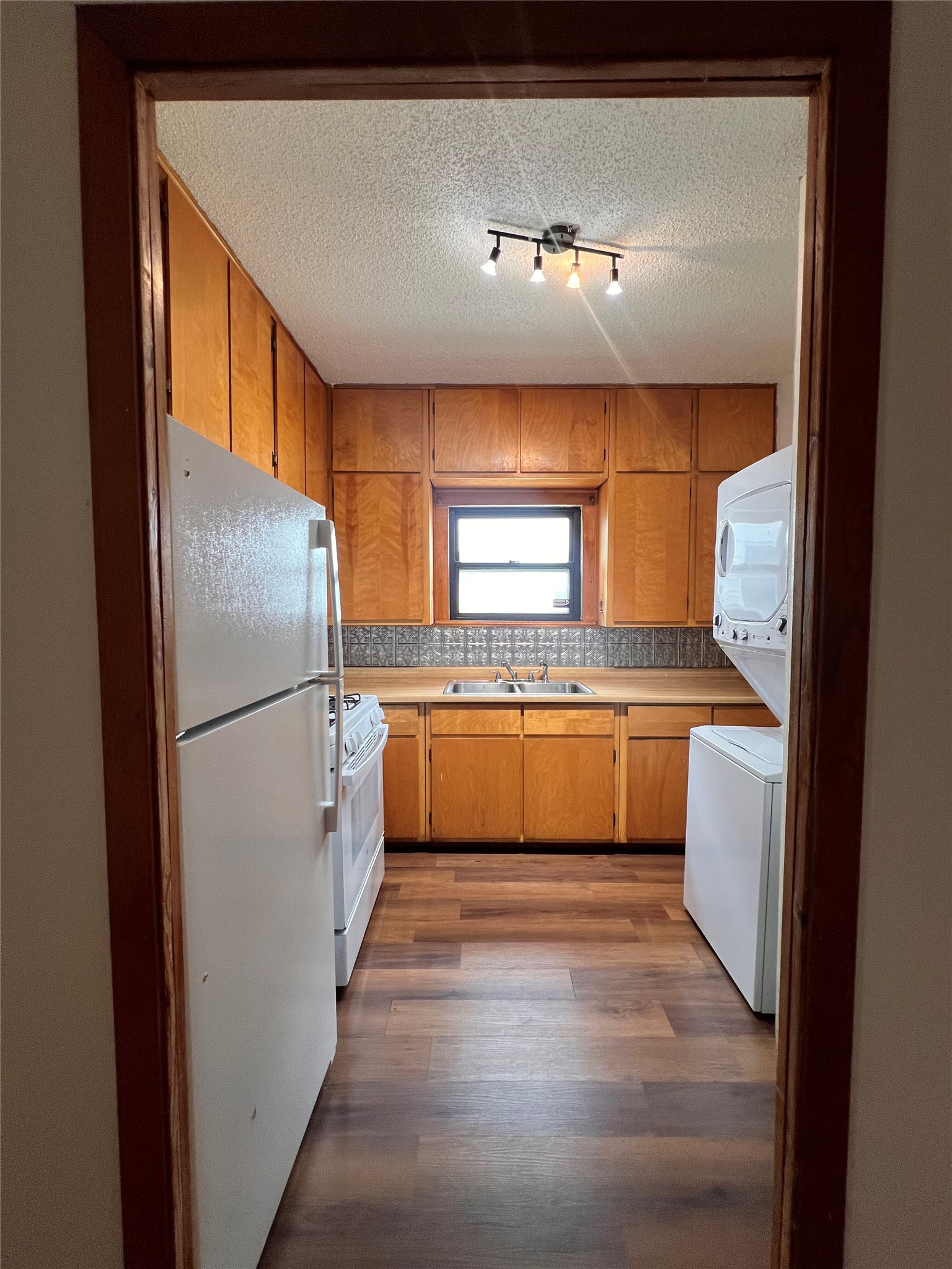 941 East 52nd Street Austin, TX 78751 - Photo 16 of 26 a large white kitchen with a refrigerator a sink a stove and a window