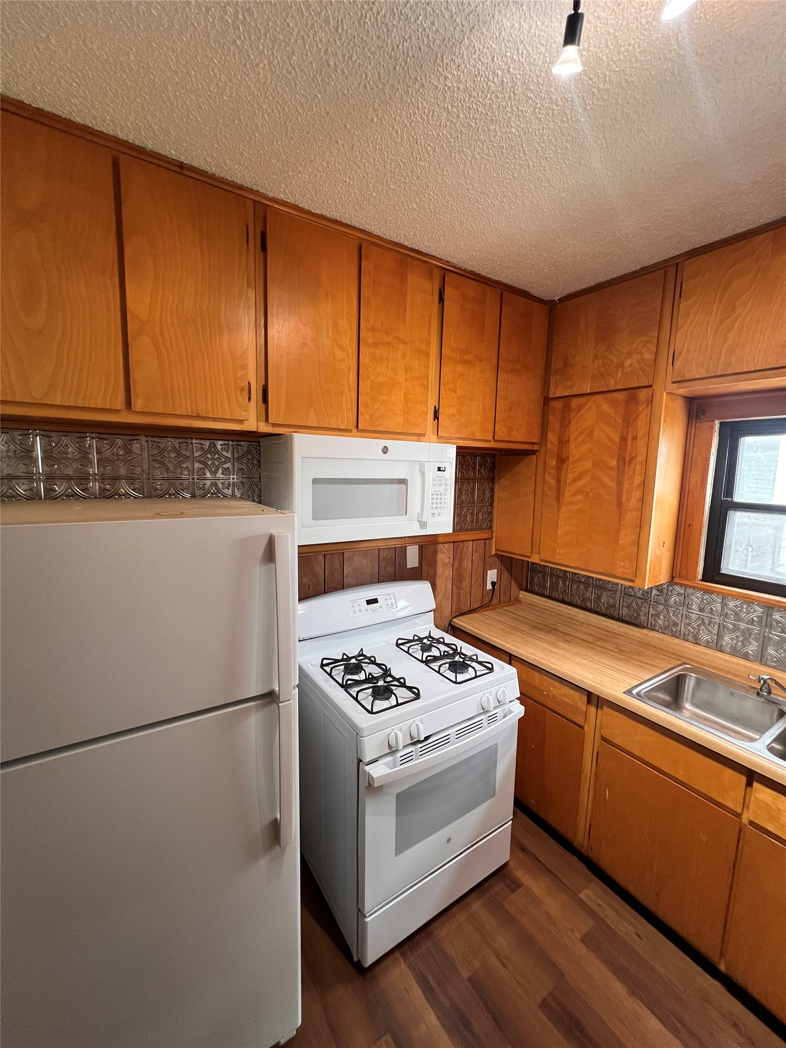 941 East 52nd Street Austin, TX 78751 - Photo 17 of 26 a kitchen with a white stove top oven and refrigerator