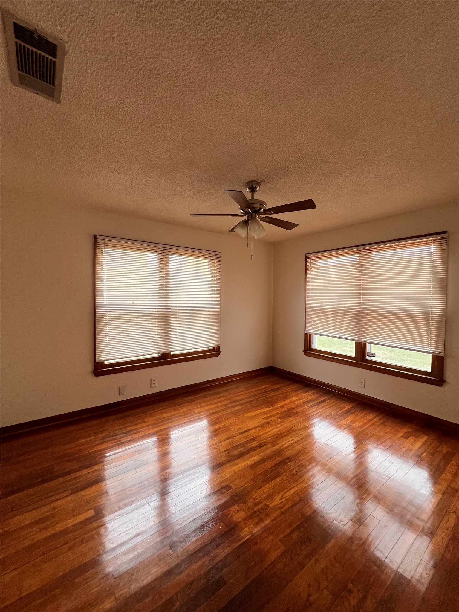 941 East 52nd Street Austin, TX 78751 - Photo 21 of 26 a view of empty room with wooden floor and fan