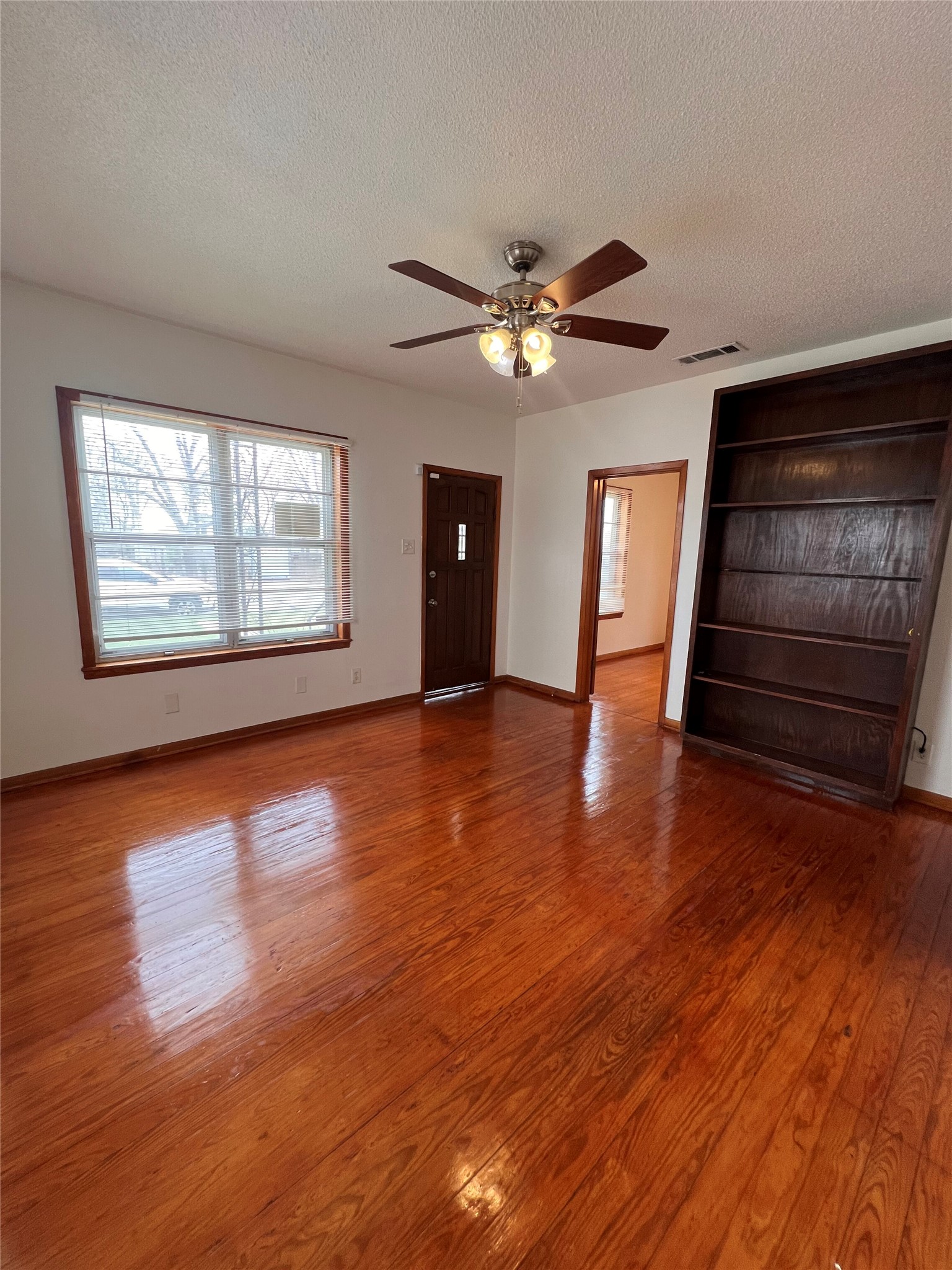 941 East 52nd Street Austin, TX 78751 - Photo 9 of 26 a view of an empty room with wooden floor and a window
