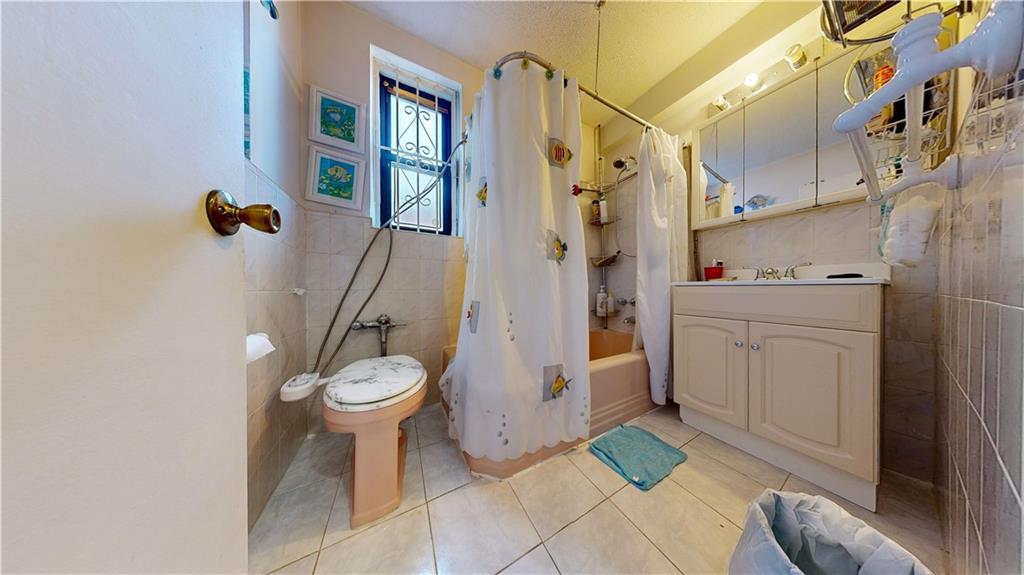 7401 Shore Road, Unit 6F Brooklyn, NY 11209 - Photo 11 of 14 a bathroom with a sink toilet and shower