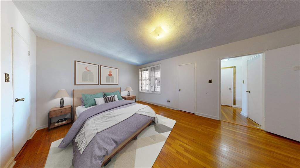 7401 Shore Road, Unit 6F Brooklyn, NY 11209 - Photo 4 of 14 a bedroom with a bed and wooden floor