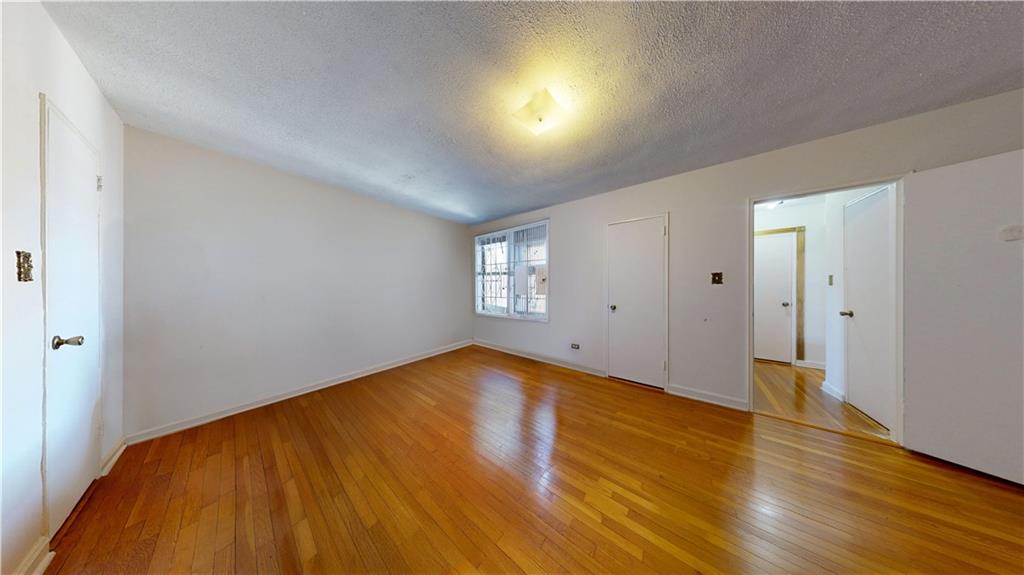 7401 Shore Road, Unit 6F Brooklyn, NY 11209 - Photo 9 of 14 a view of empty room with wooden floor and fan