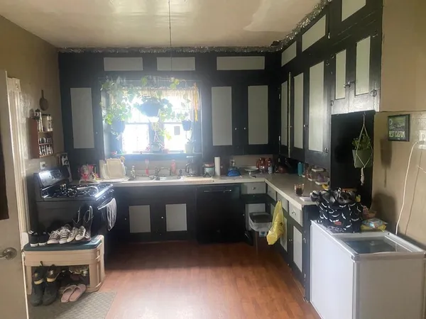 a large white kitchen with a large window
