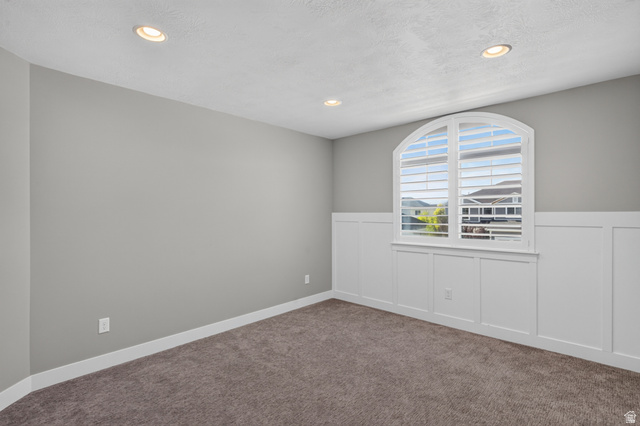 36 West Syracuse Road Vineyard, UT 84059 - Photo 34 of 56 Room featuring an arched window with plantation shutters, recessed lighting, and board and batten wainscoting
