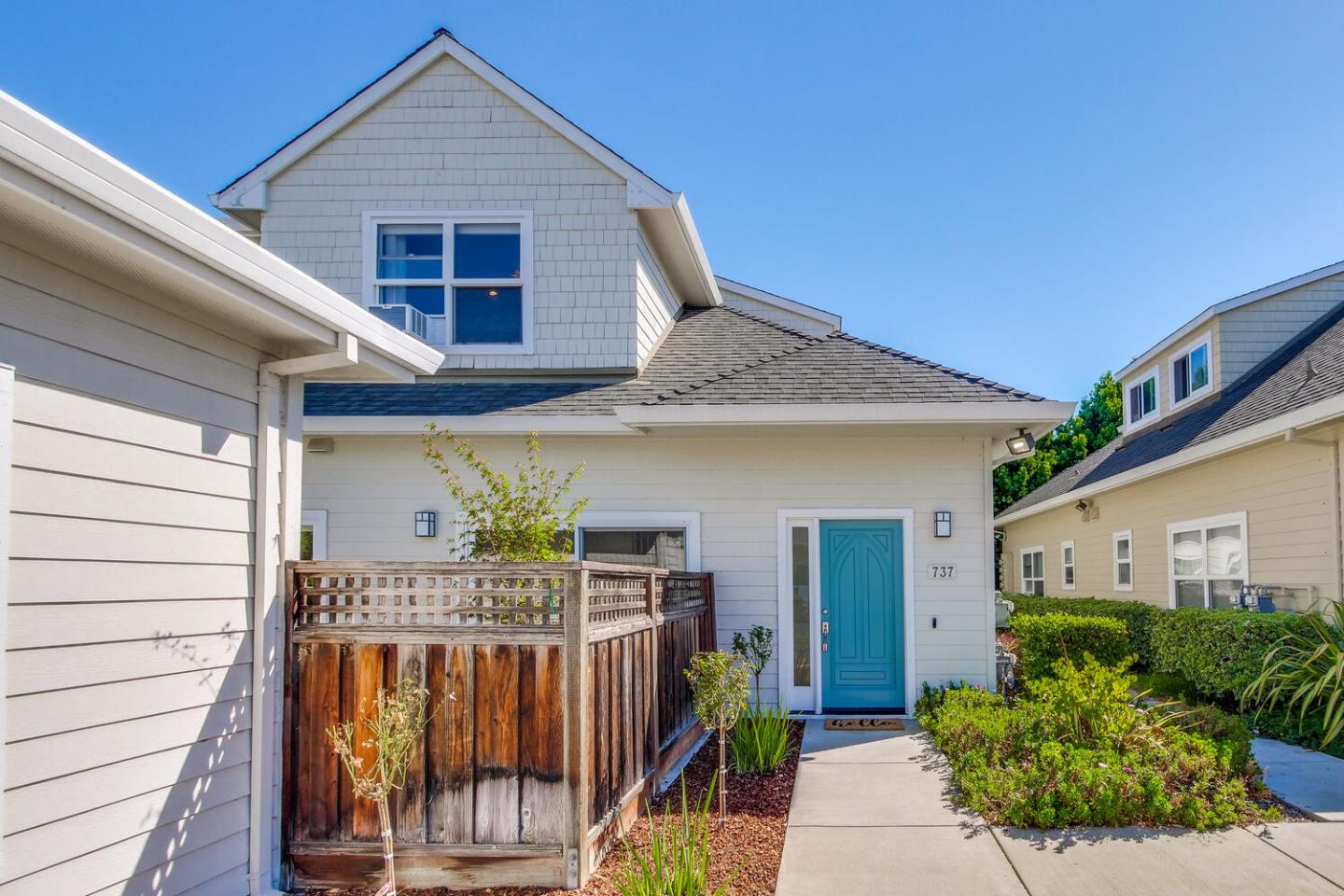 a view of a house with wooden fence