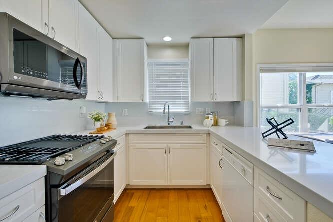 Cottage Court Mountain View, CA 94043 - Photo 16 of 43 a kitchen with a sink stove and microwave