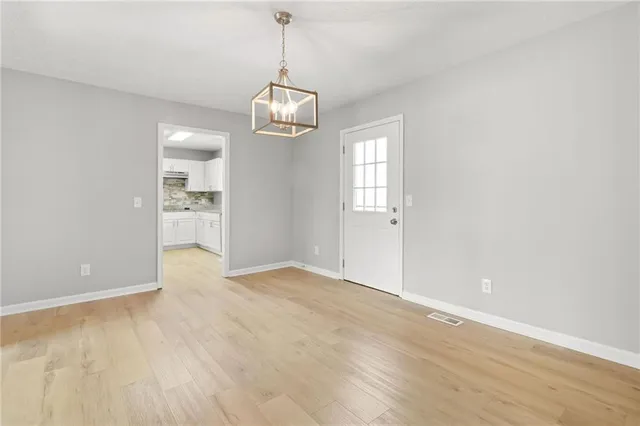 a bathroom with a granite countertop sink and a toilet