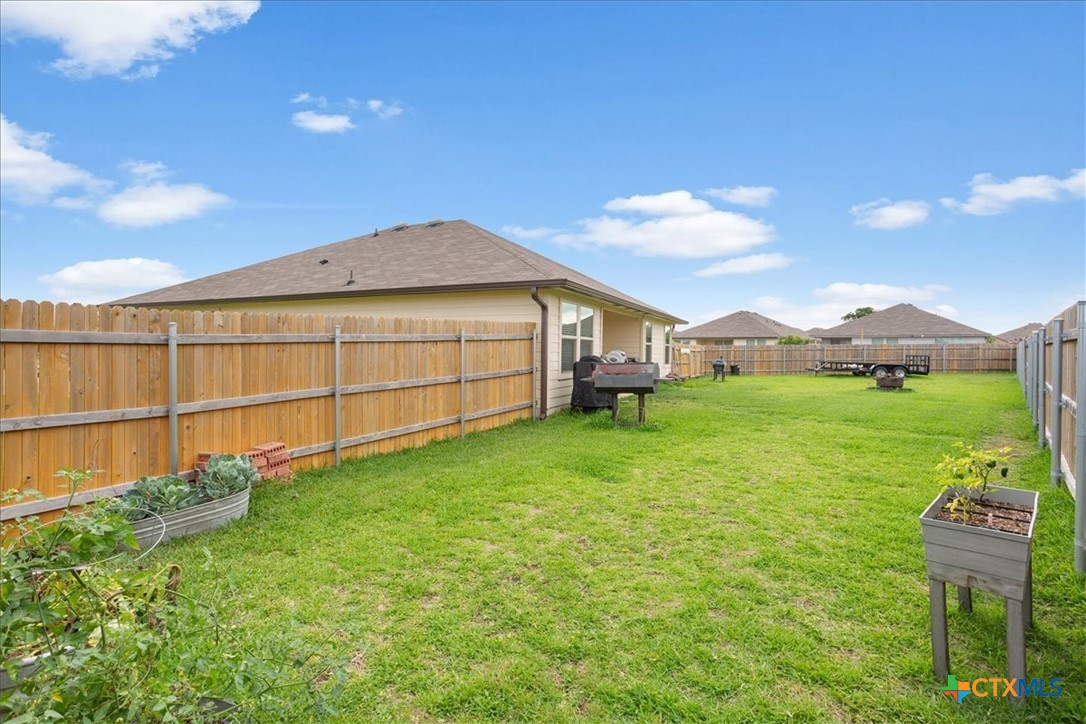 1000 Velvet Court Troy, TX 76579 - Photo 25 of 25 a view of a backyard with table and chairs