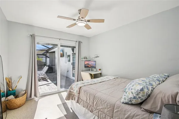 a bedroom with a bed and a potted plant