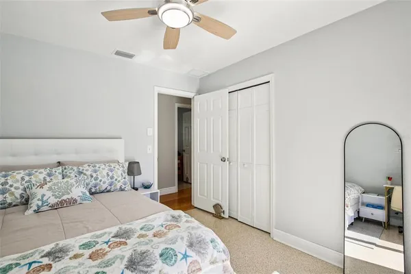 a bedroom with a bed and a mirror