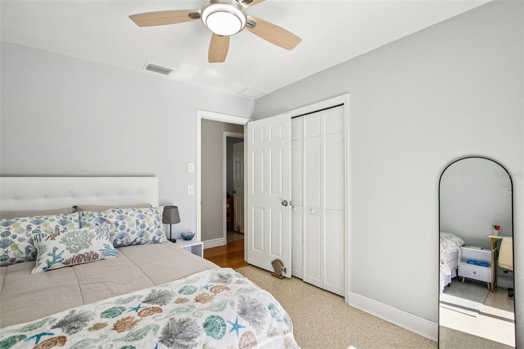 3966 High Bluff Drive Largo, FL 33770 - Photo 12 of 40 a bedroom with a bed and a mirror