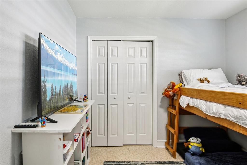 3966 High Bluff Drive Largo, FL 33770 - Photo 14 of 40 a bedroom with a bed and a tv