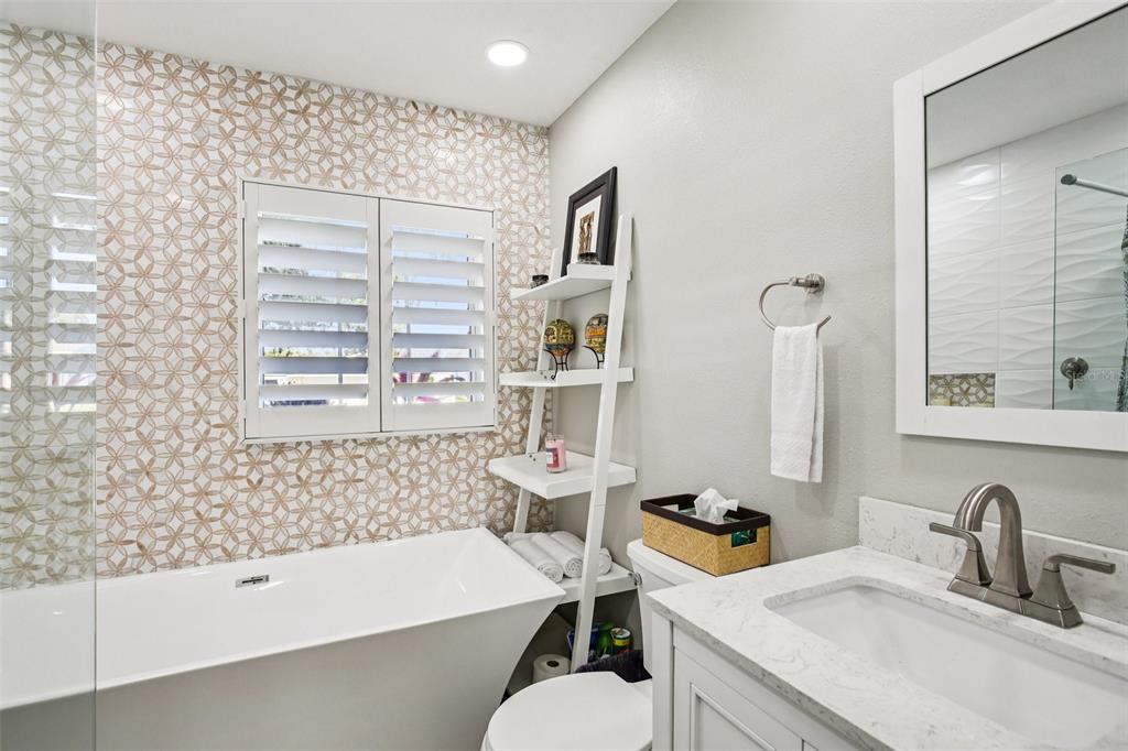 3966 High Bluff Drive Largo, FL 33770 - Photo 15 of 40 a bathroom with a sink and a bathtub