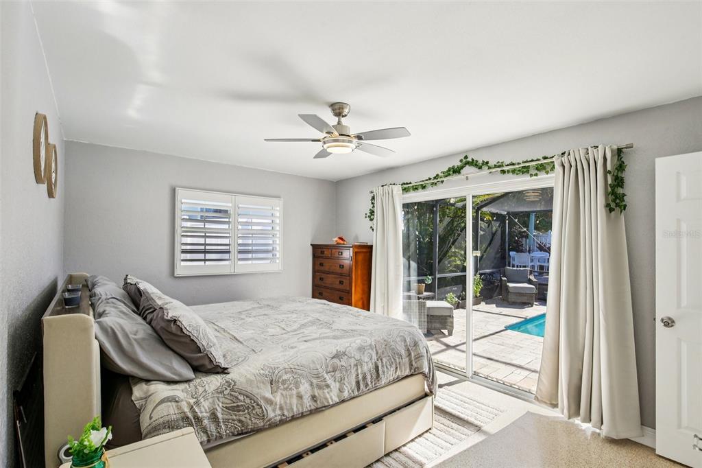 3966 High Bluff Drive Largo, FL 33770 - Photo 19 of 40 a bedroom with a bed and glass walk in closet