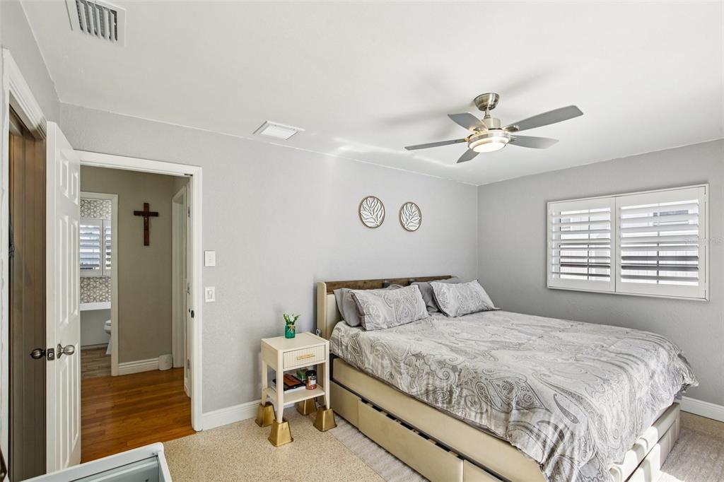 3966 High Bluff Drive Largo, FL 33770 - Photo 20 of 40 a bedroom with a large bed a chandelier and closet