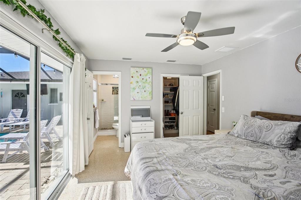 3966 High Bluff Drive Largo, FL 33770 - Photo 21 of 40 a bedroom with a large bed and a chandelier