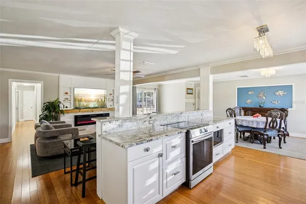 a kitchen with stainless steel appliances granite countertop a stove and a wooden cabinets
