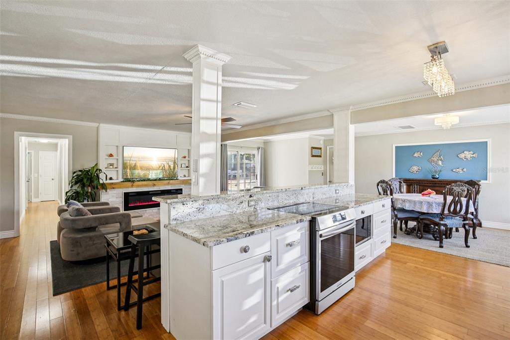 3966 High Bluff Drive Largo, FL 33770 - Photo 26 of 40 a kitchen with stainless steel appliances granite countertop a stove and a wooden cabinets