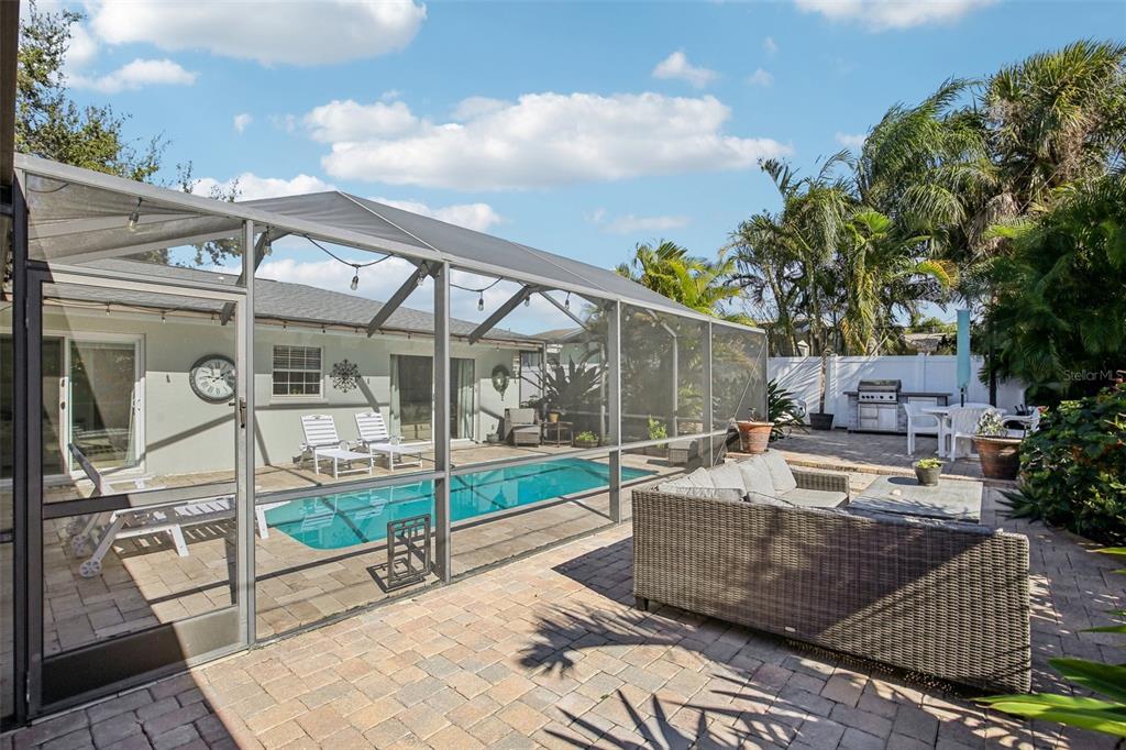3966 High Bluff Drive Largo, FL 33770 - Photo 33 of 40 a view of a patio with couches and table and chairs with wooden floor and fence
