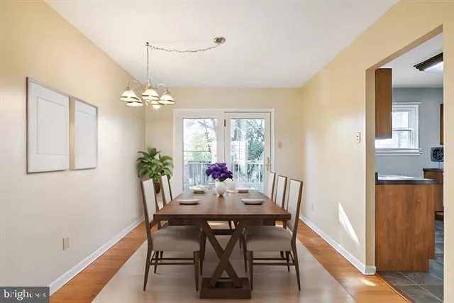 a view of a dining room with furniture and chandelier