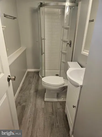 a bathroom with a toilet and a shower
