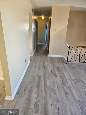 a view of hallway with wooden floor