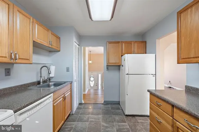 a kitchen with a refrigerator a sink and a stove
