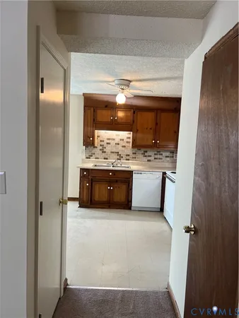 a kitchen with stainless steel appliances a sink and a refrigerator
