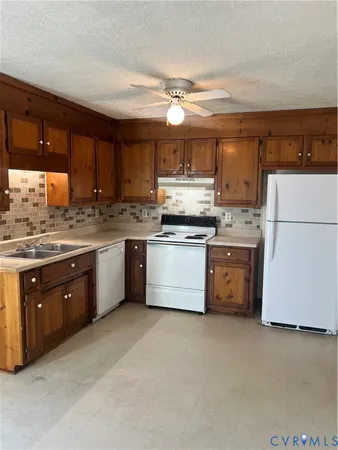 a kitchen with stainless steel appliances granite countertop a stove sink and cabinets