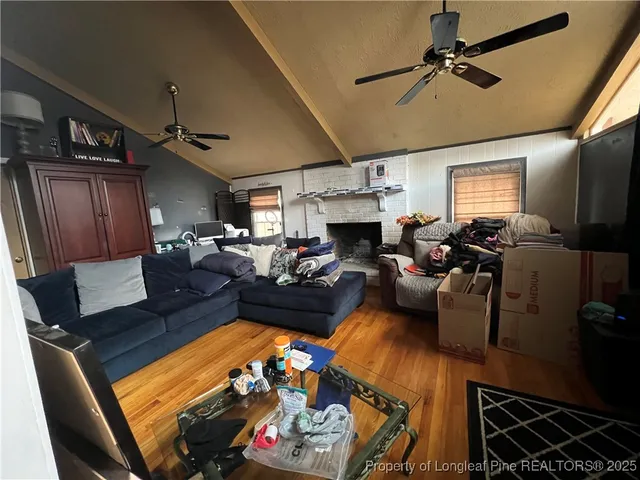 a living room with furniture fireplace and a window
