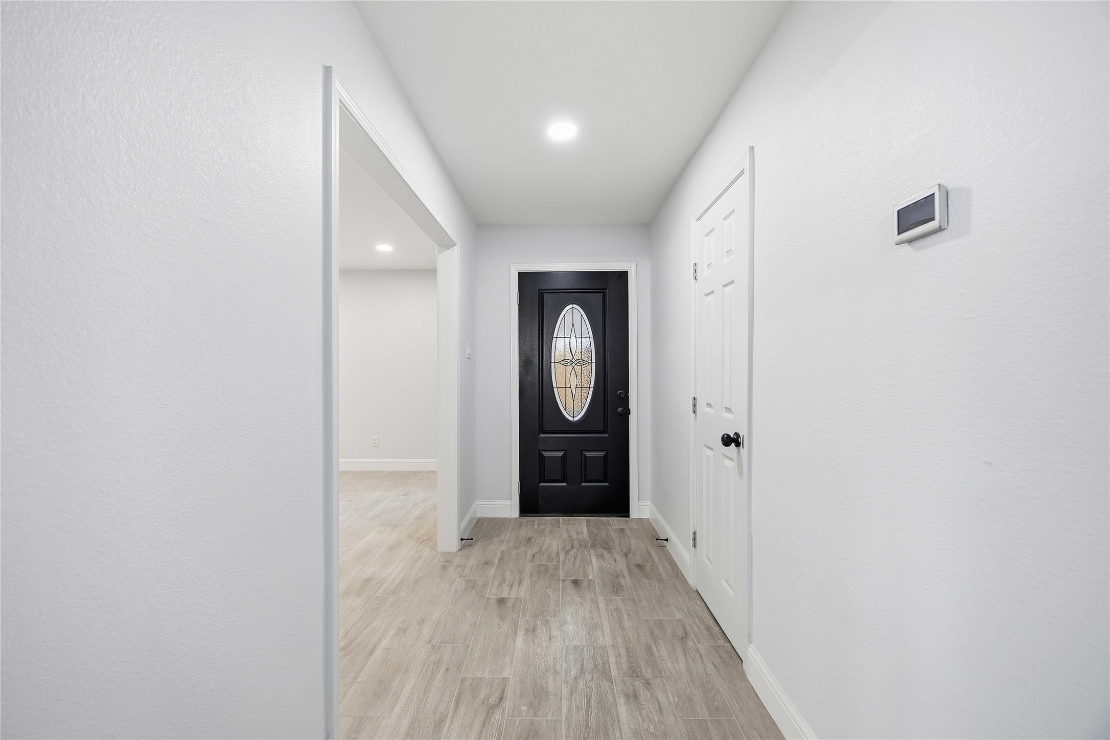 8115 Tarbell Road Houston, TX 77034 - Photo 3 of 24 a view of an empty room with wooden floor and cabinet