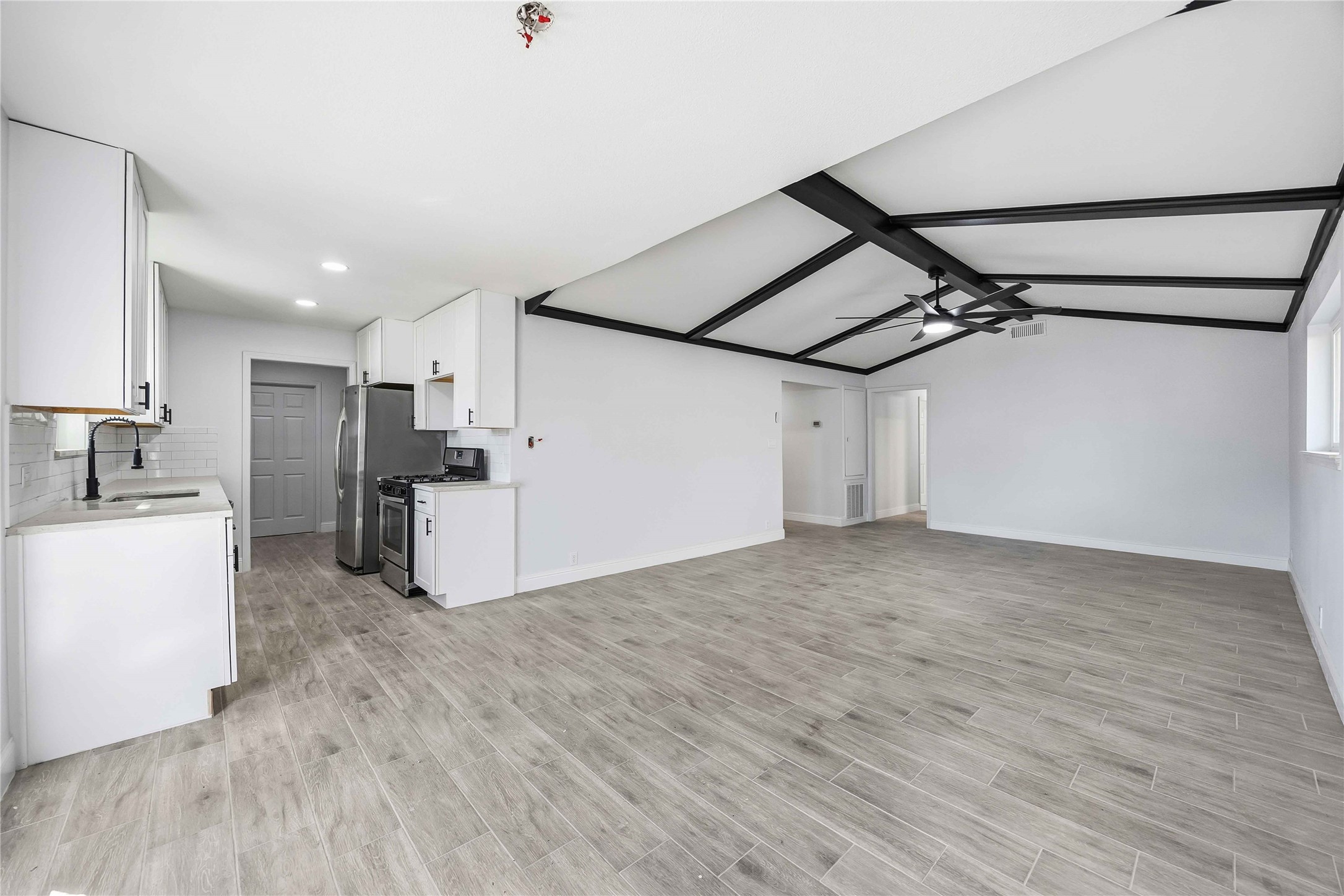 8115 Tarbell Road Houston, TX 77034 - Photo 8 of 24 a view of a kitchen with a refrigerator and a stove top oven