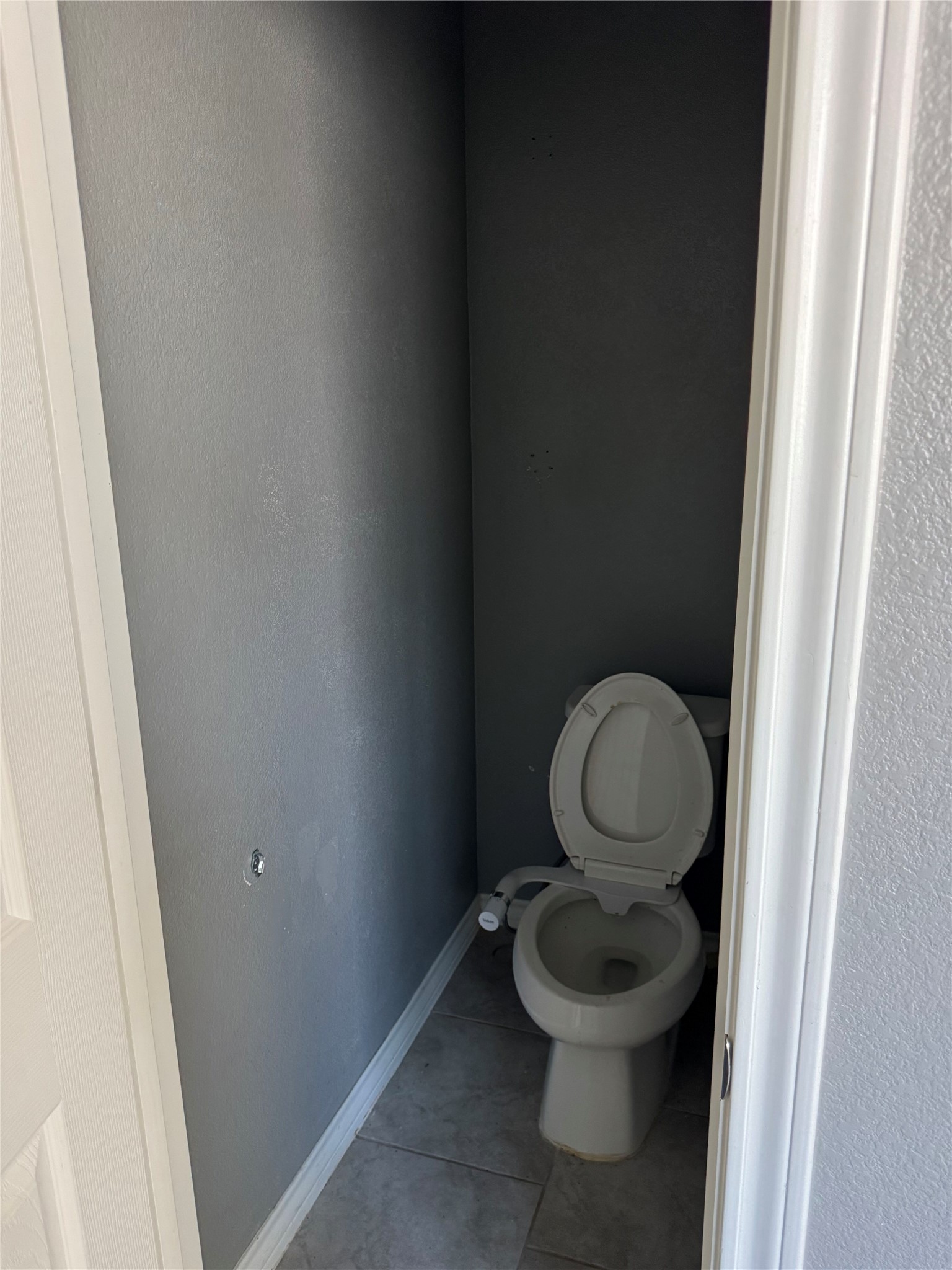 333 Capstone Road Liberty Hill, TX 78642 - Photo 24 of 40 Bathroom with light tile patterned flooring and a textured wall